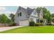 Side view of the home with a two-car garage and well-manicured lawn at 6610 Major Dr, Cumming, GA 30040