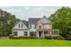 Charming two-story home with stone accents, a welcoming front porch, and a lush green lawn at 6610 Major Dr, Cumming, GA 30040