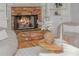 Close-up view of a stone fireplace with built-in shelves, and hardwood floors at 6610 Major Dr, Cumming, GA 30040