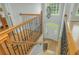 Foyer with a view to the front door, windows, and stairs with wood railing at 6610 Major Dr, Cumming, GA 30040
