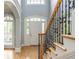 Elegant staircase with wood and iron railing leading to the front door with sidelights at 6610 Major Dr, Cumming, GA 30040