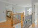 Upstairs landing featuring hardwood floors and a railing with a wrought iron design at 6610 Major Dr, Cumming, GA 30040