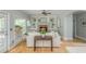 Bright living room featuring hardwood floors, a fireplace, and elegant built-in bookshelves at 6610 Major Dr, Cumming, GA 30040