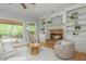 Comfortable living room offering stone fireplace, built-in shelves, and hardwood floors at 6610 Major Dr, Cumming, GA 30040