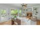 Cozy living room with stone fireplace, and an outdoor living space beyond a doorway at 6610 Major Dr, Cumming, GA 30040