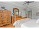 Traditional primary bedroom with natural wood furniture and a ceiling fan at 6610 Major Dr, Cumming, GA 30040
