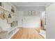 Mudroom with white wainscoting, built-in bench with shelving and storage at 6610 Major Dr, Cumming, GA 30040