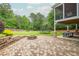 Beautiful brick patio with outdoor fireplace, seating, and ping pong table at 6610 Major Dr, Cumming, GA 30040