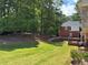 Expansive backyard featuring a well-manicured lawn, trees, and a view of the home's rear exterior at 753 Hayes Ct, Atlanta, GA 30349