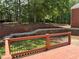 Backyard view from the home's wooden deck with retaining wall and a large grassy area at 753 Hayes Ct, Atlanta, GA 30349