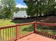 View of home's backyard from the back deck, with a lush lawn and mature trees at 753 Hayes Ct, Atlanta, GA 30349