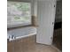 Luxurious bathroom with a deep soaking tub and window at 753 Hayes Ct, Atlanta, GA 30349