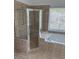 Bright bathroom showcasing a soaking tub and glass-enclosed shower with neutral tile at 753 Hayes Ct, Atlanta, GA 30349