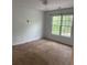Neutral bedroom featuring a large window and plush carpet, ready for personalization at 753 Hayes Ct, Atlanta, GA 30349