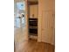 Well-lit kitchen area with built-in stainless steel double ovens, white cabinets and hardwood floors at 753 Hayes Ct, Atlanta, GA 30349
