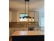 Modern kitchen features a light fixture above island and stainless steel appliances at 753 Hayes Ct, Atlanta, GA 30349