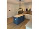 Gourmet kitchen with large island, stainless steel appliances, and white cabinetry at 753 Hayes Ct, Atlanta, GA 30349