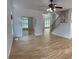 Bright living room featuring hardwood floors, an elegant staircase, and a ceiling fan at 753 Hayes Ct, Atlanta, GA 30349