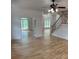Bright living room featuring hardwood floors, an elegant staircase, and a ceiling fan at 753 Hayes Ct, Atlanta, GA 30349
