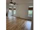 Spacious living room featuring hardwood floors, fireplace, and well-lit windows with woven blinds at 753 Hayes Ct, Atlanta, GA 30349