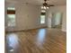 Spacious living room featuring hardwood floors, fireplace, and well-lit windows with woven blinds at 753 Hayes Ct, Atlanta, GA 30349