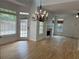 Open-concept living room with hardwood flooring, fireplace, and glass patio doors at 753 Hayes Ct, Atlanta, GA 30349