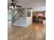 Bright living room featuring hardwood floors, elegant staircase, and opening to the kitchen at 753 Hayes Ct, Atlanta, GA 30349