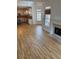 Bright living room featuring hardwood floors, fireplace, and opening to the kitchen at 753 Hayes Ct, Atlanta, GA 30349