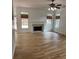 Spacious living room featuring hardwood floors, fireplace, and well-lit windows with woven blinds at 753 Hayes Ct, Atlanta, GA 30349
