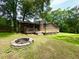 Back of house with large yard, patio area and stone fire pit at 942 Batesville Rd, Canton, GA 30115