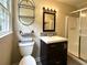 Updated bathroom featuring a sleek vanity, modern fixtures, and glass-enclosed shower at 942 Batesville Rd, Canton, GA 30115