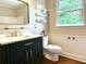 Stylish bathroom featuring a modern vanity, gold fixtures, and a bright window at 942 Batesville Rd, Canton, GA 30115