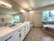 Bathroom with dual sink vanity, a garden tub, and modern fixtures at 942 Batesville Rd, Canton, GA 30115