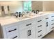Bathroom featuring a double sink vanity with white cabinets and modern fixtures at 942 Batesville Rd, Canton, GA 30115