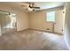 Bright bedroom features large mirrored closet, window, and neutral walls and carpet at 942 Batesville Rd, Canton, GA 30115