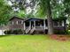Charming home with a welcoming front porch and well-maintained lawn at 942 Batesville Rd, Canton, GA 30115