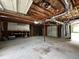 View of inside of the garage with a concrete floor and overhead door at 942 Batesville Rd, Canton, GA 30115