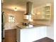Open kitchen with an island, stainless steel hood, granite countertops, and hardwood floors at 942 Batesville Rd, Canton, GA 30115