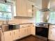 Modern kitchen with stainless steel appliances, farmhouse sink, granite countertops, and bright natural lighting at 942 Batesville Rd, Canton, GA 30115