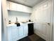 Functional kitchenette with white cabinets, sink, mini-fridge, and overhead storage at 942 Batesville Rd, Canton, GA 30115