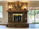 Living room featuring a stone fireplace and sliding glass doors to the deck at 942 Batesville Rd, Canton, GA 30115