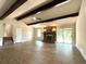 Spacious living room with stone fireplace, wood beam ceiling, and sliding glass doors at 942 Batesville Rd, Canton, GA 30115