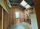 Interior view of unfinished outbuilding with wooden studs and window at 942 Batesville Rd, Canton, GA 30115