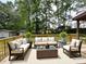 Inviting patio furnished with comfortable seating and a lush green backdrop at 942 Batesville Rd, Canton, GA 30115