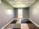 Versatile room with neutral walls, patterned carpeting, and door to the exterior at 942 Batesville Rd, Canton, GA 30115