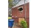 View of brick wall, window, trash receptacle and shrubbery outside this home at 2625 Baker Nw Rd, Atlanta, GA 30318