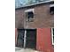 Exterior view of building with brick exterior and security door on cinderblock base at 2625 Baker Nw Rd, Atlanta, GA 30318