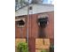 Exterior image showing brick siding, boarded window, and shrubbery at 2625 Baker Nw Rd, Atlanta, GA 30318