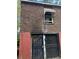 Exterior view of the brick building showing window and security doors at 2625 Baker Nw Rd, Atlanta, GA 30318