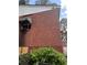 Image showing brick siding, boarded window, and shrubbery outside this home at 2625 Baker Nw Rd, Atlanta, GA 30318